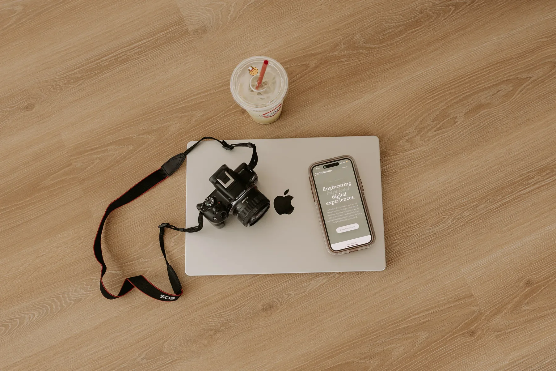 Laptop, camera, and phone arranged for website strategy and content work